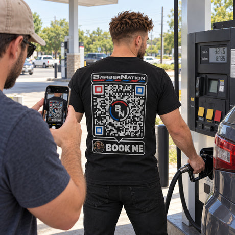 Lifestyle mockup of a barber wearing the ProPage QR T-shirt at a gas station